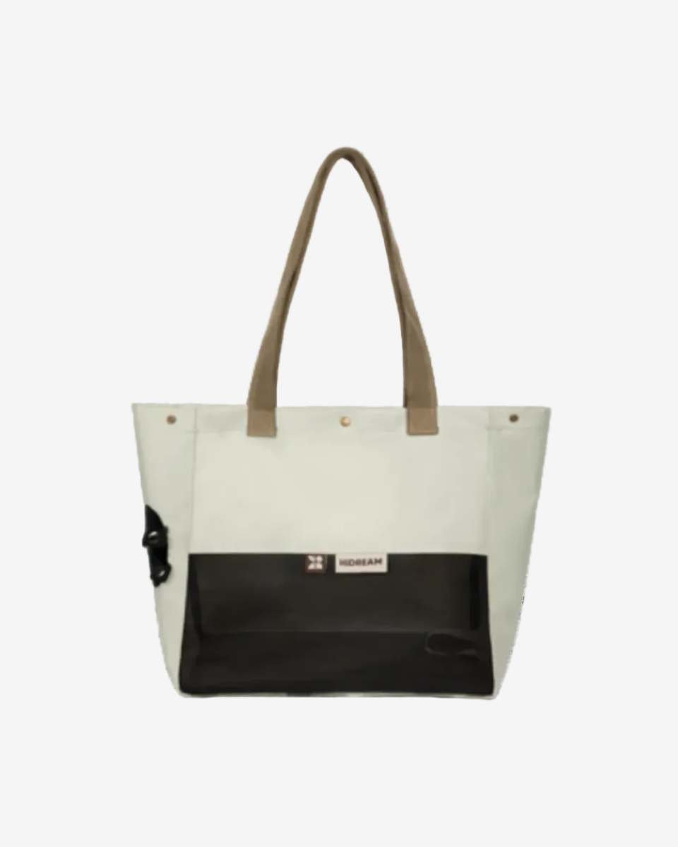 Beige pet tote bag with brown handles and black bottom section on a white background