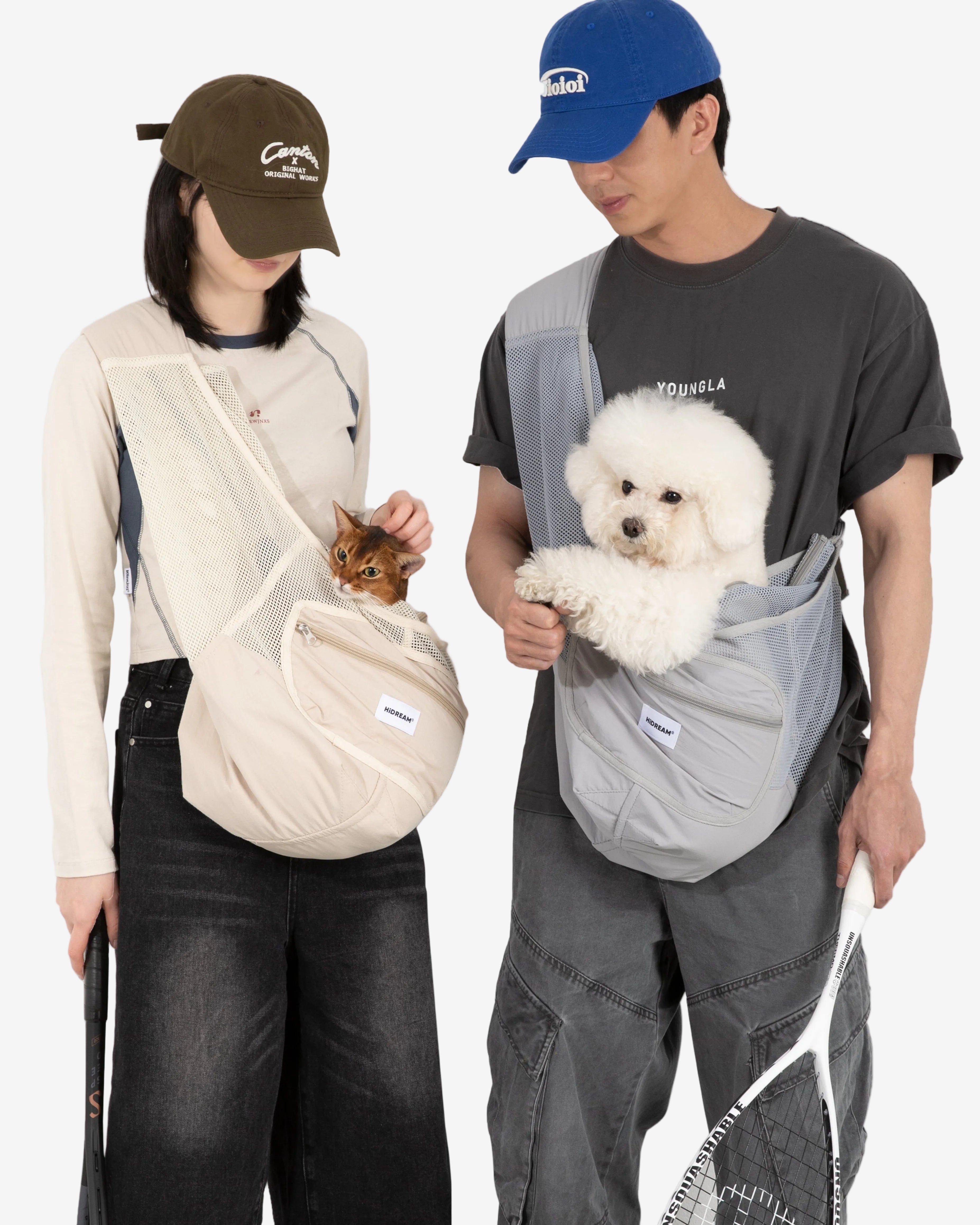 Two people using pet carriers with small dogs on a plain background