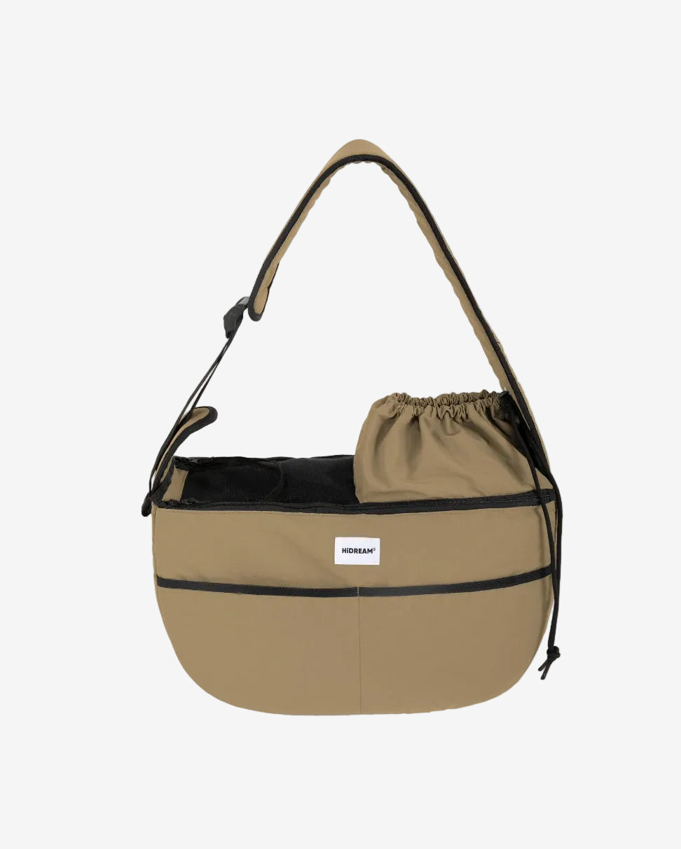 Beige bag with black accents and a drawstring pouch on a white background