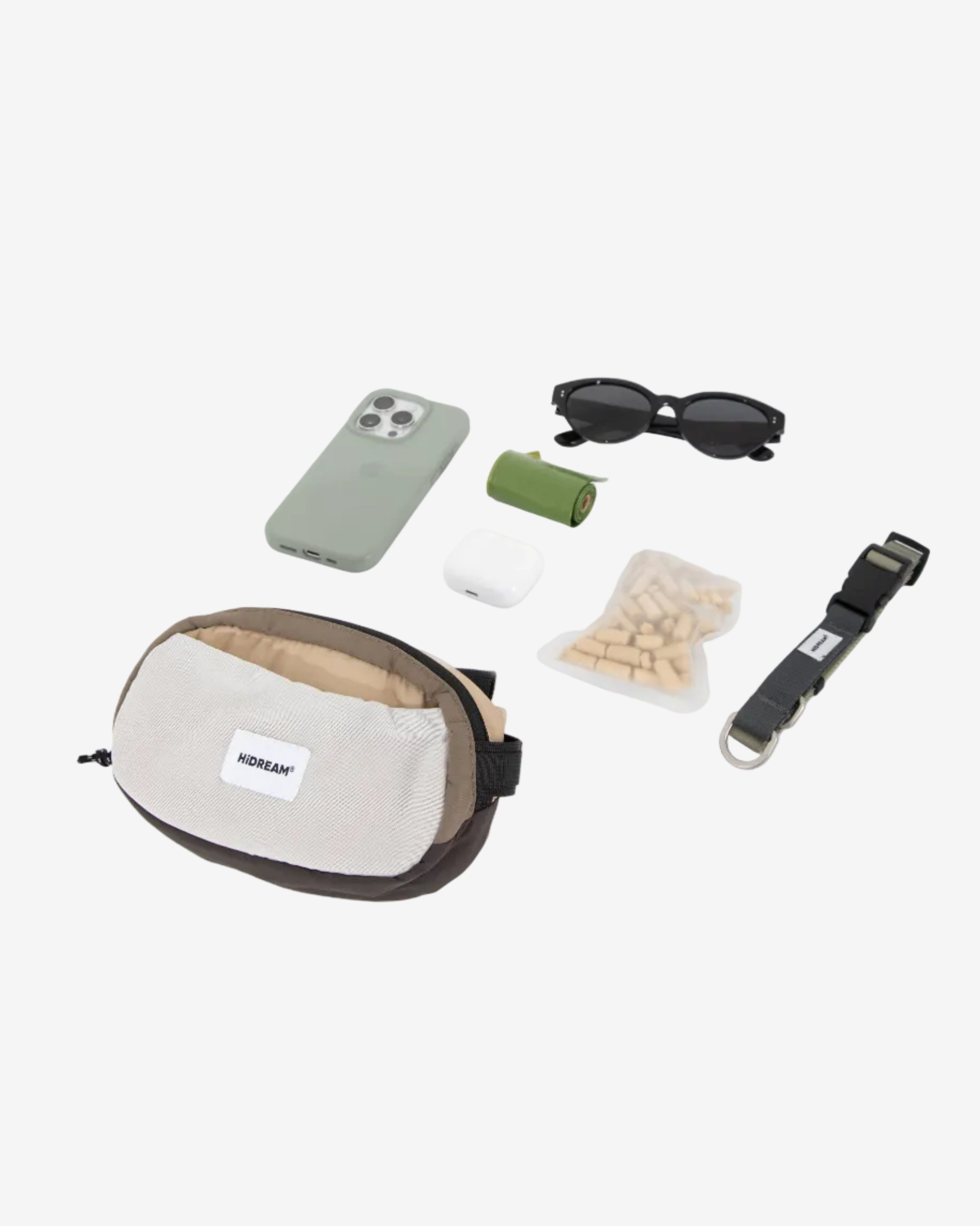 Fanny pack with various items on a light gray background