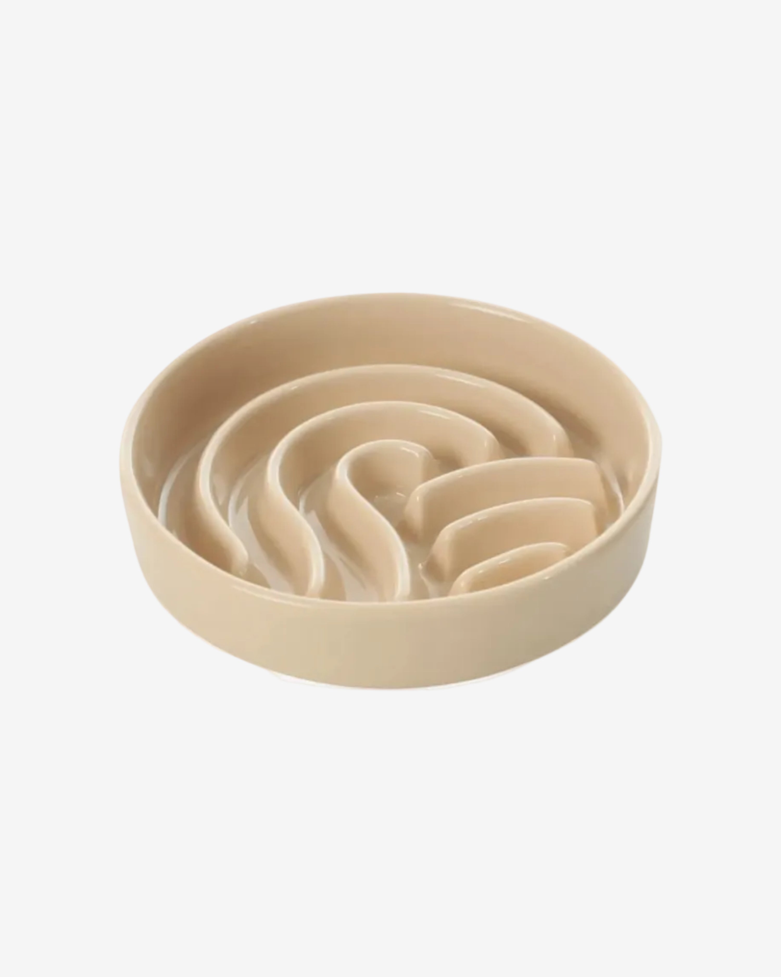 Beige wave-shaped slow feeder dog bowl on a white background