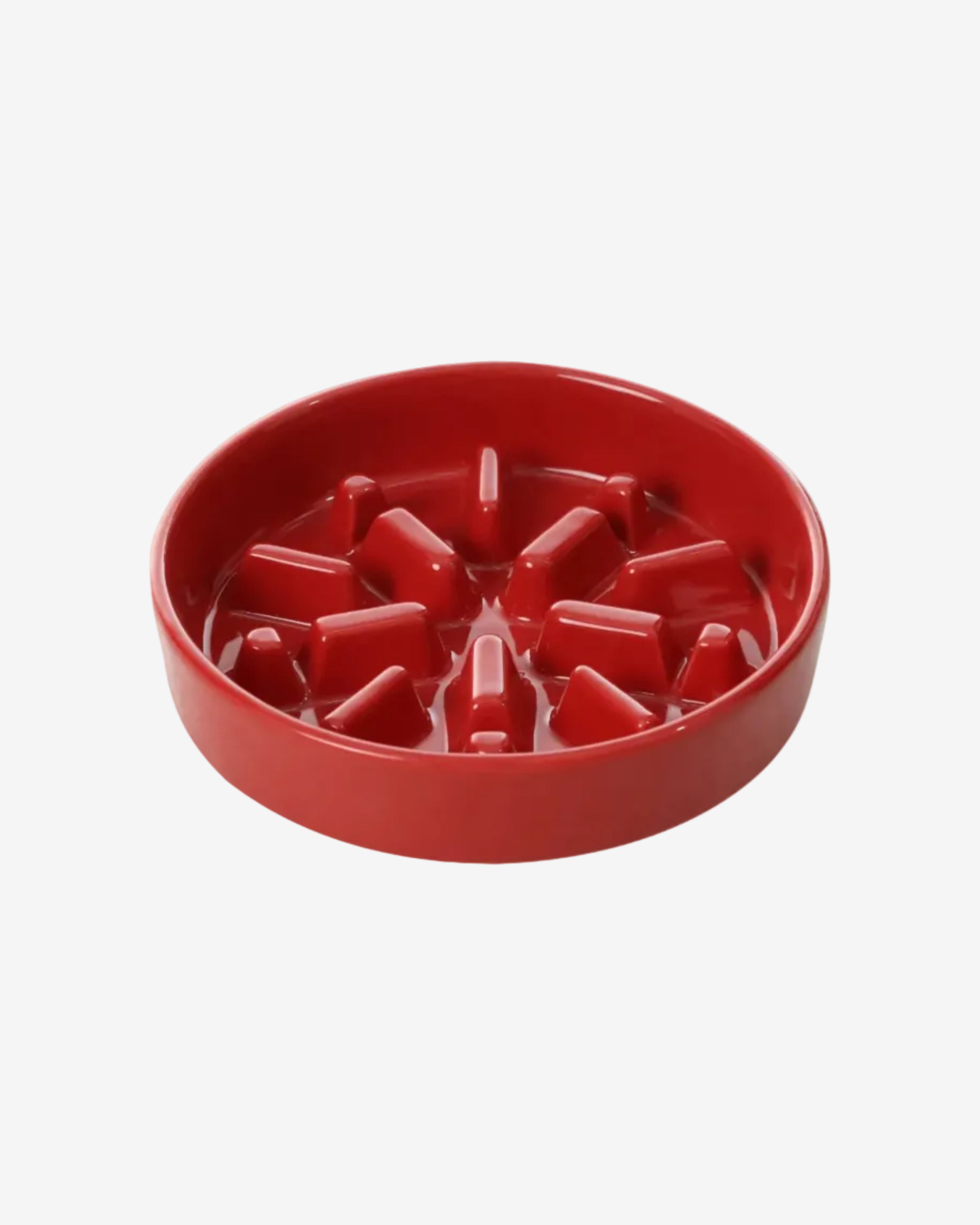 Red spark-shaped slow feeder bowl for pets on a white background