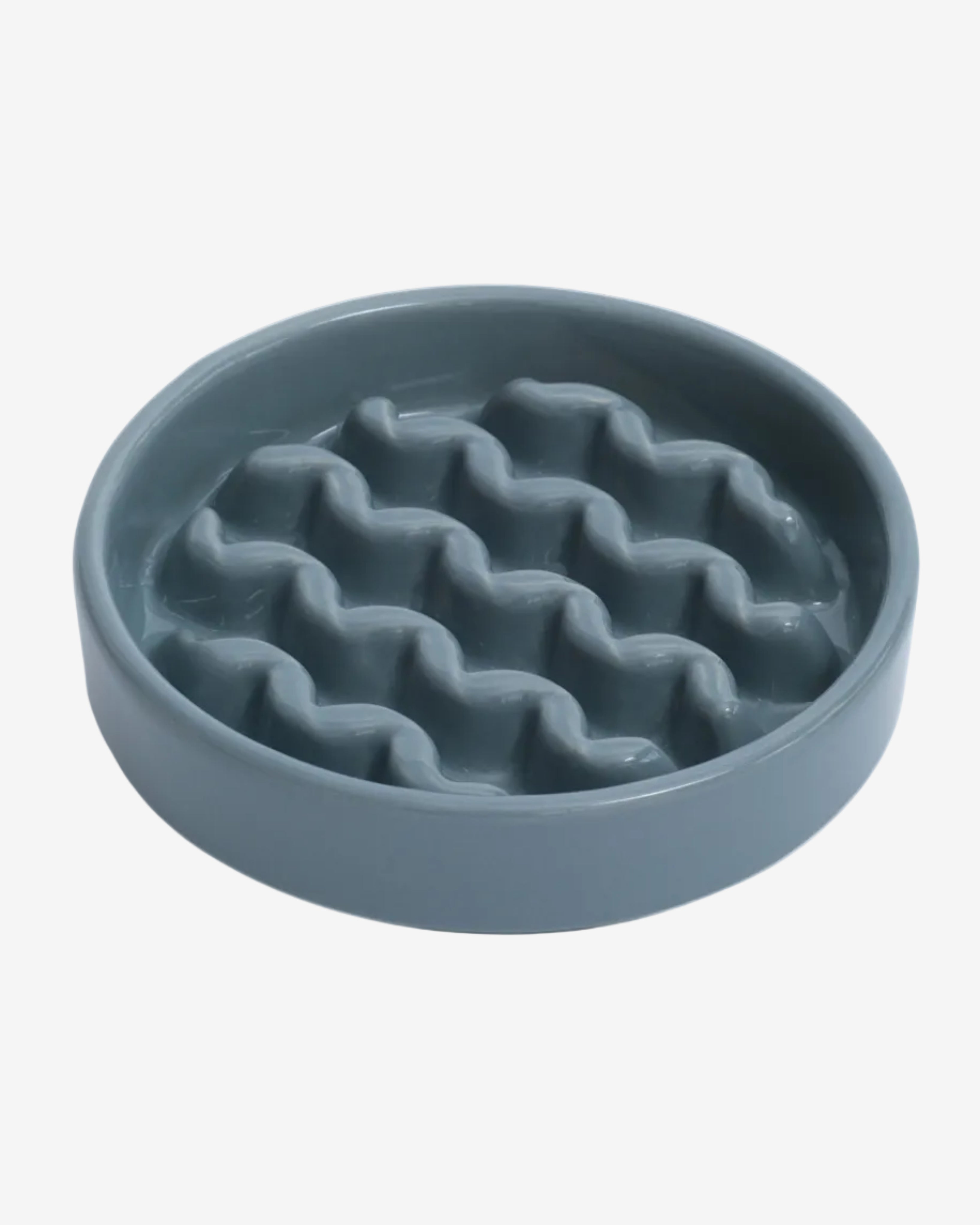 Blue macroni-shaped slow feeder bowl  on a white background