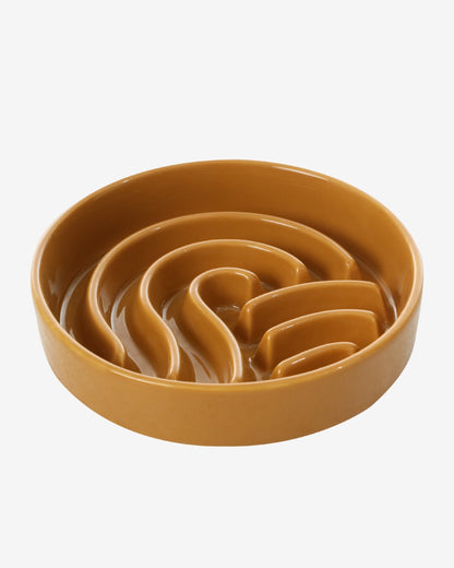 Brown wave-shaped ceramic slow feeder dog bowl on a white background