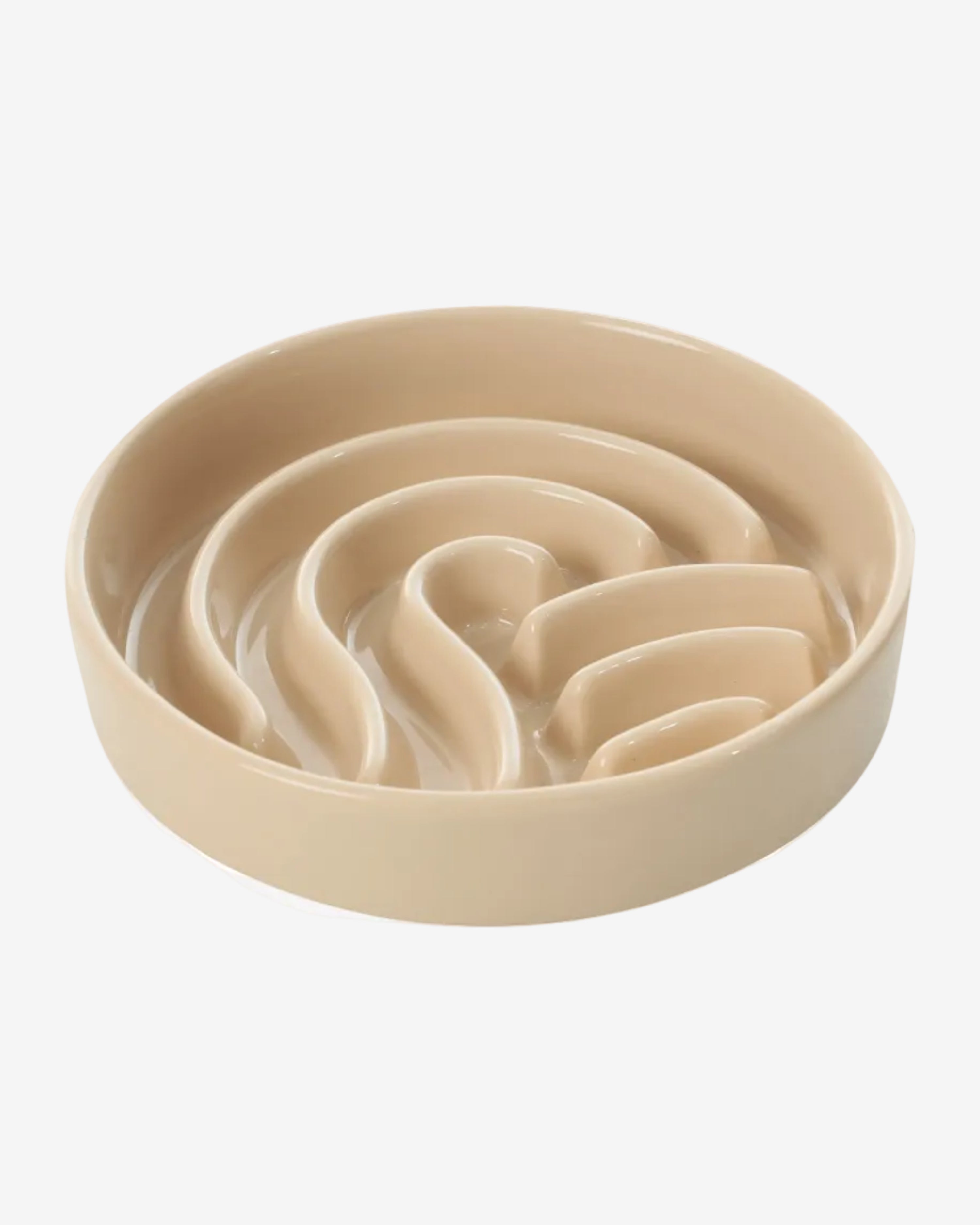 Beige wave-shaped slow feeder dog bowl on a white background