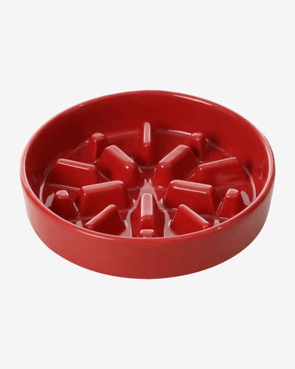 Red spark-shaped slow feeder bowl for pets on a white background