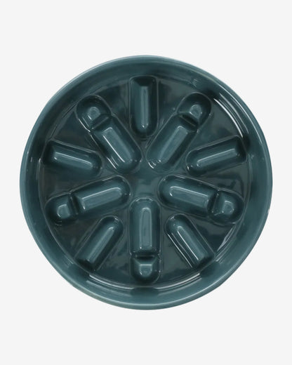 Blue spark-shaped slow feeder dog bowl on a white background